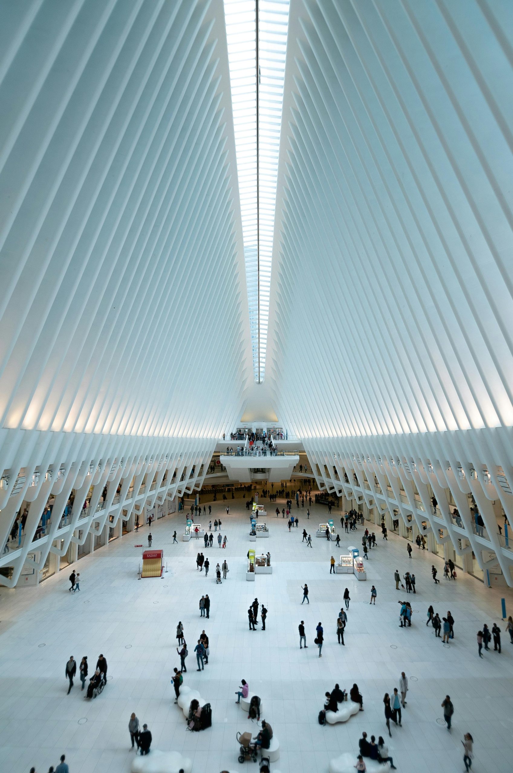 Modern architectural view of the Oculus in NYC, showcasing its futuristic design and bustling interior.